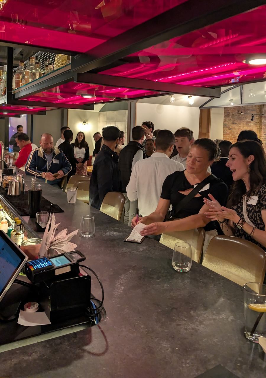 Professionals networking over cocktails at a Connect Cincy mixer at the Moxy Hotel bar in downtown Cincinnati